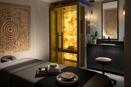 a bedroom with a bed and a sink and a mirror at Hotel Yellowstone at Jackson Hole in Jackson
