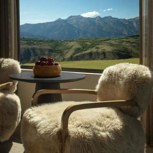 a chair with a bowl of fruit sitting in front of a window at Hotel Yellowstone at Jackson Hole in Jackson