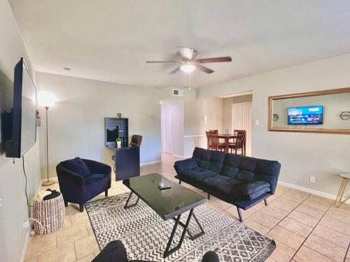 a living room with a couch and a table at KING SUITE 2BR Home w FAST WiFi, & WFH Desk in San Antonio