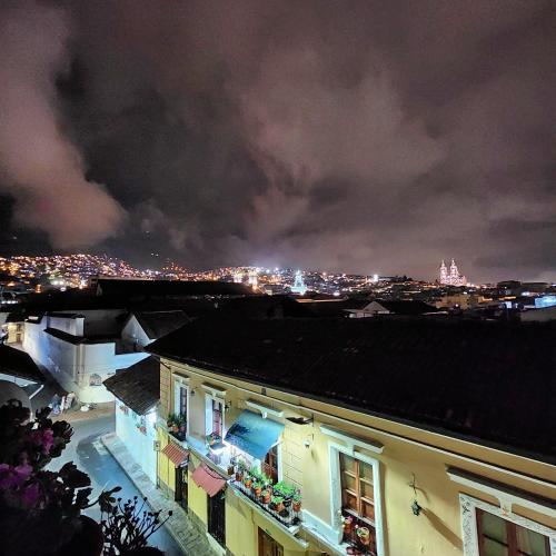 a view of a city at night with lights at Hotel Boutique Casa San Marcos in Quito