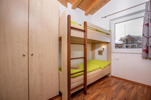 a bunk bed in a room with a window at Chalet Central Top CC 7 in Königsleiten