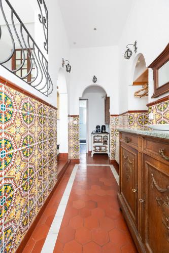 - une cuisine avec du carrelage coloré sur les murs dans l'établissement Appartement authentique à colombage 15mn de Disney, à Ferrières-en-Brie