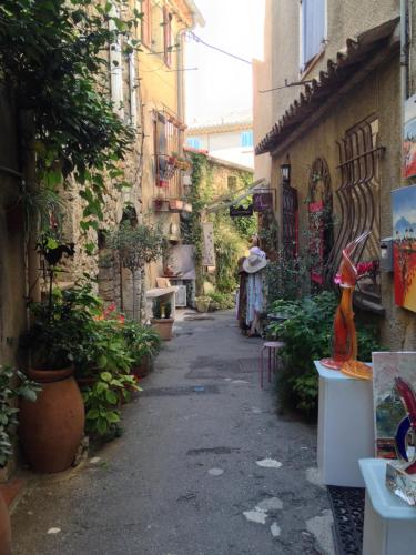 an alley with flowers and plants in a building at Villa Oleander, Mougins in Mougins