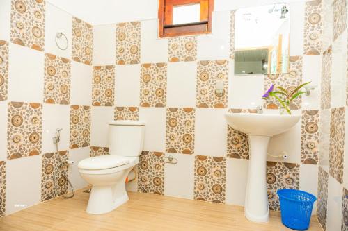 a bathroom with a toilet and a sink at Hanguk Villa Mirissa in Mirissa