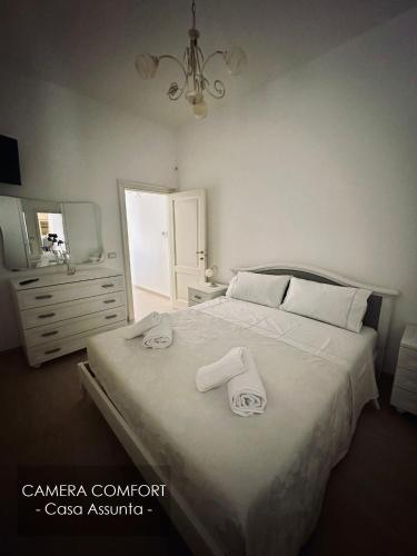 Postel nebo postele na pokoji v ubytování casa vacanze Assunta