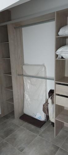 a room with a closet with a bed and shelves at L'ECUREUIL in Bousbach