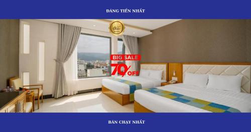 a large hotel room with two beds and a big sale sign at Anh Phuong Hotel & Apartment in Da Nang
