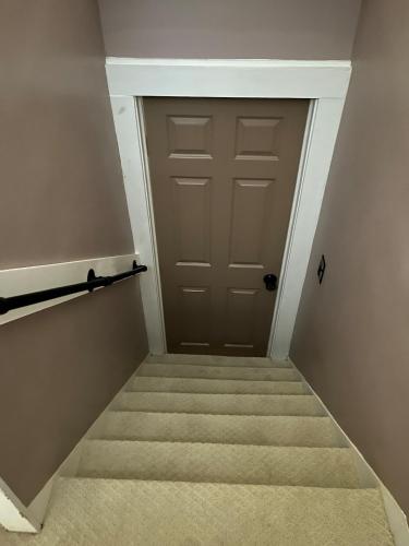 a stairway with a door in a room at Elevated Entertainment Sleep Suite in Cleveland