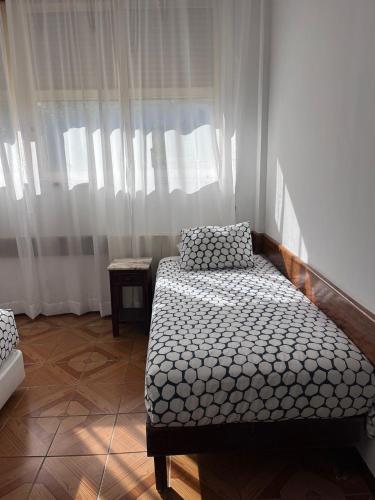 a small room with a bed and a window at Hotel Brites in Chaves