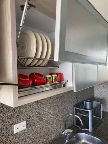 a kitchen counter with a sink and some dishes at Moderno y cómodo apartamento in Cúcuta