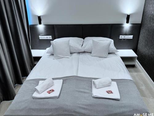 a large bed with two white towels on it at AMuSE ME in Kielce