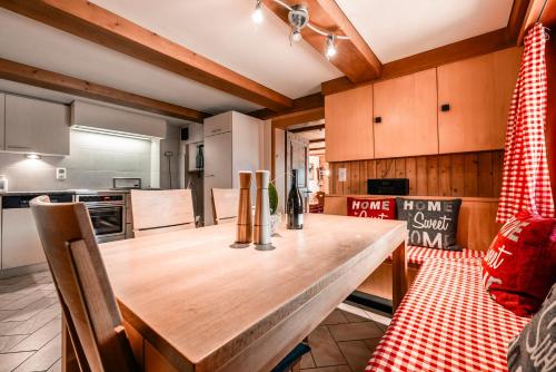 a kitchen with a wooden table in a room at Casa Marie in Malans