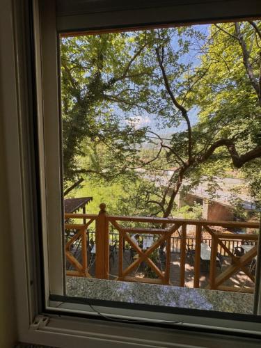 a window with a view of a wooden balcony at Bar Restaurant Hotel Gysi in Klos