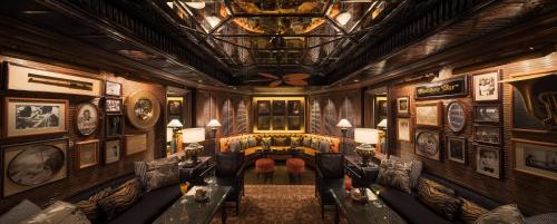 a living room with a couch and a table at Mandarin Oriental, Bangkok in Bangkok