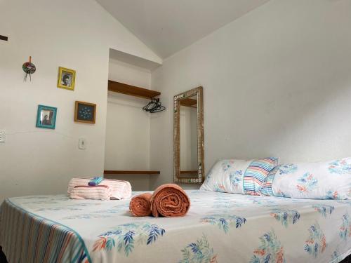 a bedroom with two beds and a mirror at Hospedaria Canto Itaúnas in Itaúnas