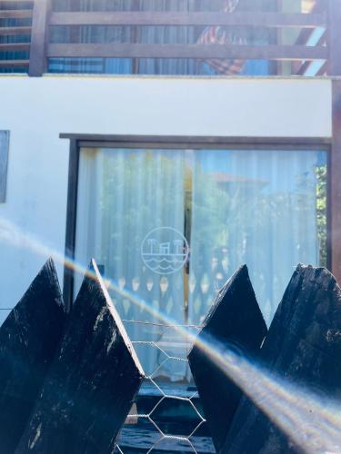 a close up of a window with blue glass at Hospedaria Canto Itaúnas in Itaúnas