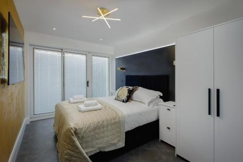 a bedroom with a bed and a ceiling fan at Swish Luxury Holiday Apartments in Blackpool
