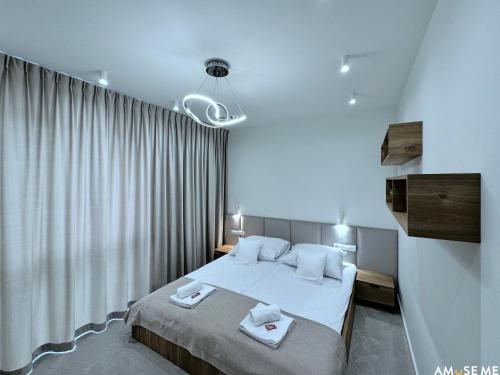 a bedroom with a bed with two towels on it at AMuSE ME in Kielce