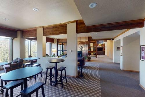 a lobby with tables and chairs in a building at Platinum Studio Pool-Spa Ski-in out Gym, Sauna, Laundry, BBQ in Brian Head
