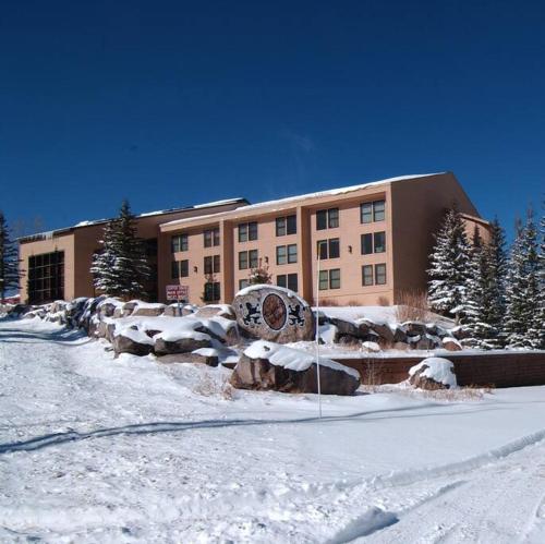 a large building with snow in front of it at Platinum Studio Pool-Spa Ski-in out Gym, Sauna, Laundry, BBQ in Brian Head
