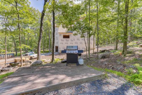a building with a grill on a wooden deck at Screened Porch and Deck Pet-Friendly Poconos Escape in Lackawaxen