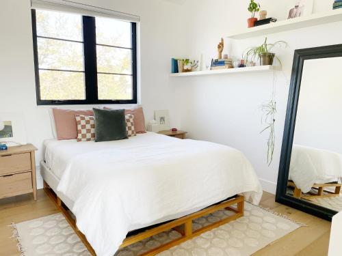 a bedroom with a bed and a mirror at Black Barn Ranch 25 Acres Wpool Near Downtown in San Luis Obispo