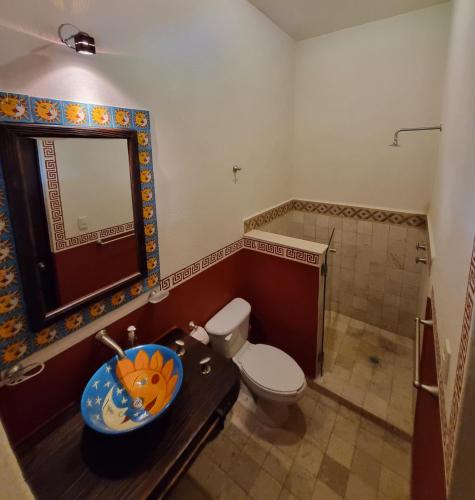 a bathroom with a toilet and a sink at Hacienda Maria Eugenio in Guanajuato
