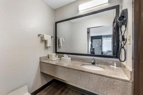 a bathroom with a sink with a large mirror at Quality Inn Glasgow in Glasgow