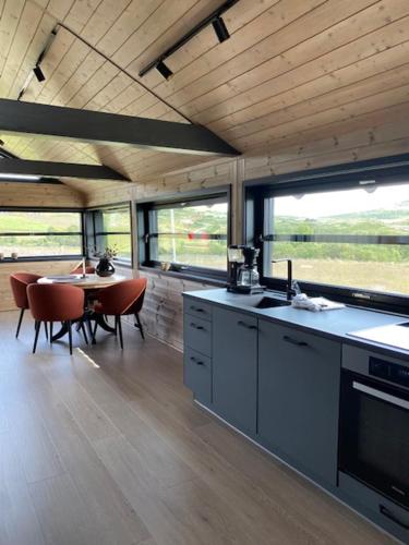 a kitchen and dining area of a house with a table at Høvringen Fjellstue in Høvringen