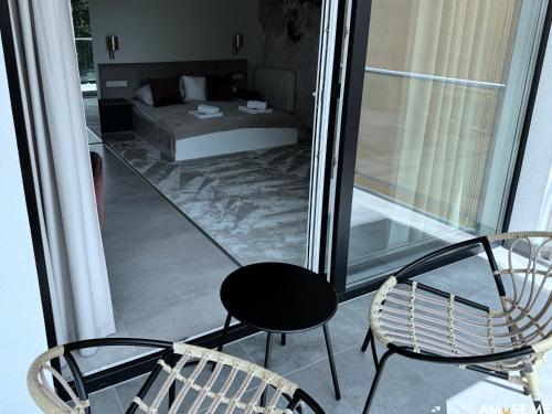 a room with a bed and two chairs on a balcony at AMuSE ME in Kielce