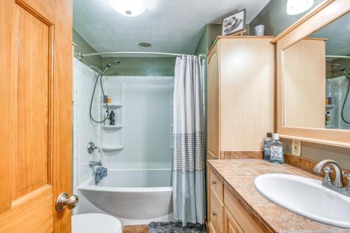 a bathroom with a tub and a shower and a sink at Picturesque Phoenix Vacation Home on Oswego River! in Phoenix