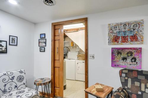 a living room with a door leading to a kitchen at Picturesque Phoenix Vacation Home on Oswego River! in Phoenix