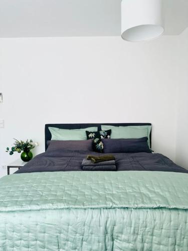 a bedroom with a large bed with purple sheets at City Center Apartments Düsseldorf in Düsseldorf