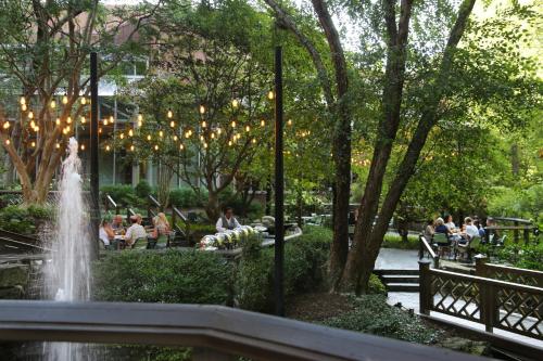 a fountain in a park with people sitting on benches at Crowne Plaza Atlanta Perimeter at Ravinia by IHG in Atlanta