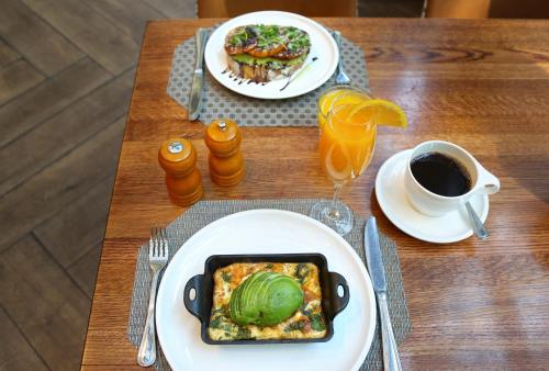 a table with two plates of food and a cup of coffee at Crowne Plaza Atlanta Perimeter at Ravinia by IHG in Atlanta