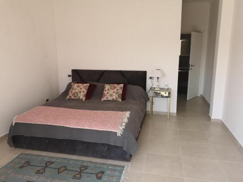 a bedroom with a large bed and a table at Hillside Villa in Mifol