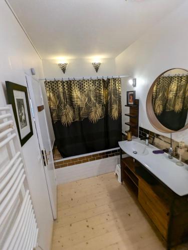 une salle de bain avec un lavabo et un rideau de douche dans l'établissement Au Bonheur des Dames, à Vedène