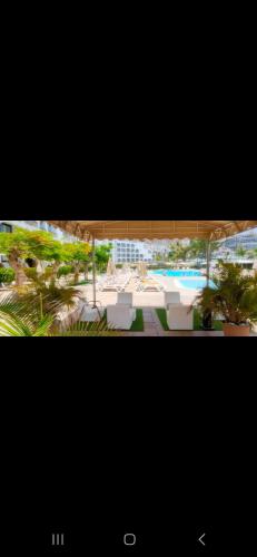 a view of a resort with chairs and a pool at BH Cura marina 2 in Mogán