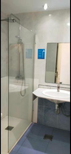 a bathroom with a sink and a shower and a mirror at BH Cura marina 2 in Mogán
