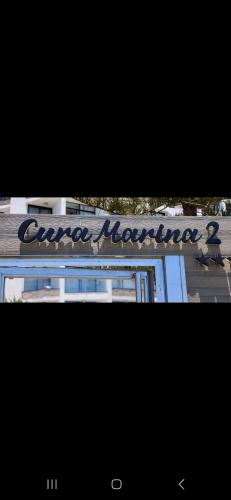 two pictures of a building with a sign on it at BH Cura marina 2 in Mogán