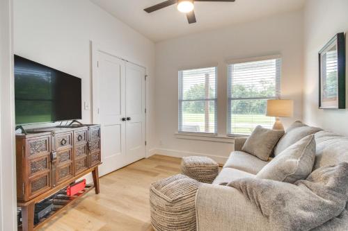a living room with a couch and a flat screen tv at Flippin Vacation Rental Walk to White River! in Flippin