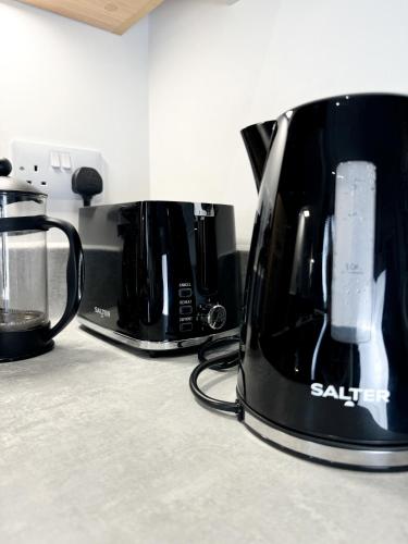 a toaster and coffee maker on a kitchen counter at Stokes Croft - Whole Apartment - City Centre - Serviced Accommodation BS1 in Bristol