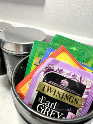 a metal can filled with lots of different colored packets at Stokes Croft - Whole Apartment - City Centre - Serviced Accommodation BS1 in Bristol