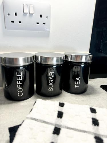 three black buckets sitting on top of a counter at Stokes Croft - Whole Apartment - City Centre - Serviced Accommodation BS1 in Bristol
