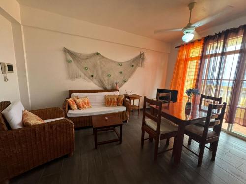 a living room with a couch and a table at Las Palmeras by Graziano in Boca Chica