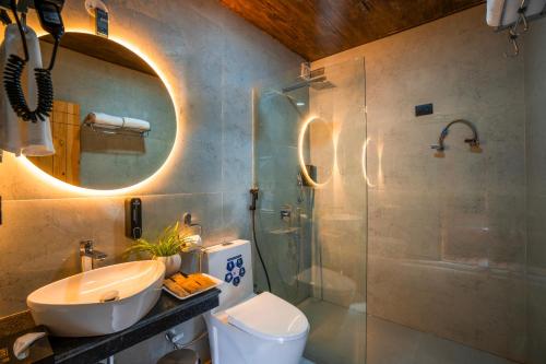 a bathroom with a toilet and a sink and a shower at Olgah Manali in Manāli