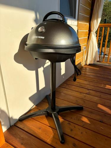 a grill sitting on a wooden floor on a porch at Ayana Mobile Home in Orebić