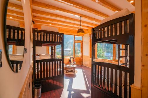 a room with wooden walls and a hallway with a door at Olgah Manali in Manāli