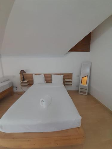 a bedroom with a large white bed in a room at Las Palmeras by Graziano in Boca Chica