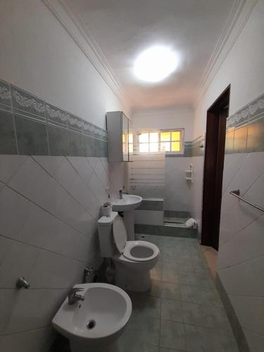 a bathroom with a toilet and a sink at Las Palmeras by Graziano in Boca Chica